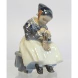 Royal Copenhagen porcelain figure of a seated girl darning a sock, no. 1314, 1923 green underglaze