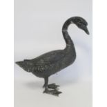 Black painted cast metal garden ornament in the form of a swan, 58cm high.