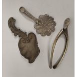 Silver caddy spoon of scrolling vine leaf form, another filigree c1820 and a wishbone tongs, 1907.