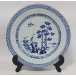 18th century Chinese export blue and white circular charger, the central panel depicting cranes in a