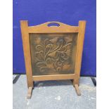 Art Nouveau hammered copper firescreen, the panel decorated with entwined stylised flowerheads, 47cm
