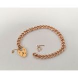 9ct gold curb link bracelet with padlock by CBL hallmarked for Birmingham 1994, 18cm length, 21g.
