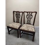 Pair of 18th century mahogany dining chairs, each with yoke top rail and pierced carved back splat