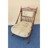 Late Victorian Aesthetic walnut nursing chair in the manner of Christopher Dresser, with turned