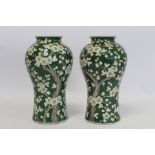 Pair of late 19th/early 20th century Japanese vases of meiping form decorated with prunus blossom on