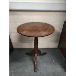 Late Georgian circular mahogany occasional table on ring turned baluster column and downswept tripod