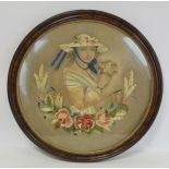 Victorian silk embroidery of a girl holding a posy of flowers with wreath of roses and grasses