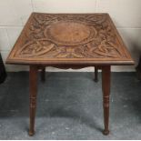 Arts & Crafts style square oak occasional table, c.1900, the top carved with scrolls and bird masks,