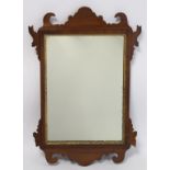 George III style walnut fret carved wall mirror with inlaid stringing and moulded gilt slip, 52cm