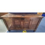 Antique oak coffer, plank top above four panel front on stile supports. H.80cm, W.147cm, D.57cm.