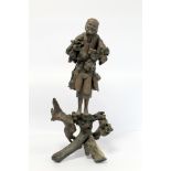 19th or early 20th century Oriental carved root wood figure of a peddler holding a shoe, the face