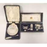 Silver three-piece condiment set with spoons, 1919, & a butter shell, with knife, both cased. 129g.