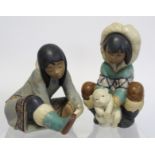 Two Lladro Gres figures of Inuit children, one crouching with polar bear cub, 20.5cm high, the other