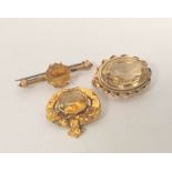 Citrine oval brooch, a similar pin, both 9ct gold and a brooch with garter mount. 14g gross (2).