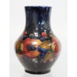 Moorcroft "Pomegranate" pattern vase of baluster form with blue ground. Impressed royal mark with