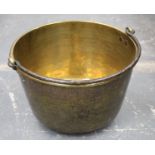 Exceptionally large antique hammered brass cooking pot or kettle of circular bucket form with iron