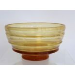 Barnaby Powell for Whitefriars ribbon trailed amber glass footed bowl with polished base, 21cm diam.