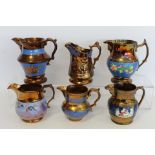 Six Victorian copper lustre jugs, four with moulded decoration, the largest 16.5cm high.  (6).