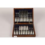 Silver plated and mother of pearl handled twelve piece fruit set; in an oak fitted box