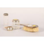 Two silver topped dressing table jars; solver backed mirror and a napkin ring