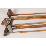 Nine hickory shafted golf clubs
