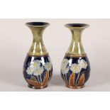 Pair of Royal Doulton stoneware vases; decorated with flowers; marks to base; 21cm high