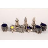 Set of four silver table salts; together with two other cruets; two spoons and three pepperettes