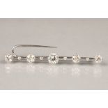 Five stone diamond bar brooch ,unmarked white metal 0.75 carat brilliant cut centre diamond, with