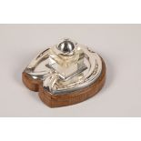 Electro plated silver ink stand, in the form of a horseshoe, mounted to an oak base, glass inkwell