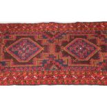 Persian belouchi rug, red ground dark blue border with geometric pattern in brown, blue and green,