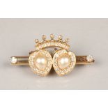 Diamond set brooch, a crown over two hearts, each heart set with a tear drop pearl, surrounded by