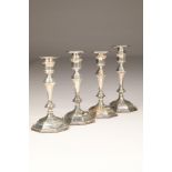 Set of four Edwardian silver candlesticks, faceted form raised on octagonal bases, assay marked