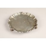 Edwardian silver salver, pie crust edge raised on three scroll feet, assay marked London 1903,