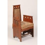 Oak arts and crafts armchair, with pierced heart decoration, width 56.5cm, height 102cm