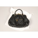 A black quilted clasp Marc Jacob satchel , with red interior and Marc Jacobs Dust bag