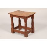 Robert Mouseman of Kilburn oak stool, the adzed saddle seat on octagonal chamfered legs united by