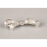 Diamond bar brooch in the form of a bow, with a centre 0.2 carat diamond, length 43mm