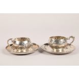 Pair Continental art noveau silver cups and saucers, embossed floral decoration, saucer diameter