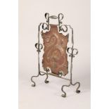 Arts and crafts copper and wrought iron fire screen, with embossed coiled dragon decoration, 82cm
