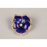 Unmarked yellow metal and enamel brooch, in the form of a flower, central diamond with blue enamel