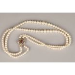 Ladies double strand cultured pearl necklace, with a 9 carat gold floral clasp set with diamonds and