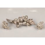 19th century unmarked white metal and diamond brooch, floral form with a matching pair of