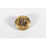 Yellow metal Victorian brooch set with four central faceted amethysts, 7.7g