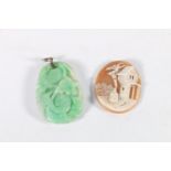 Jadeite pendant with foliate decoration and white metal mount, 15.7g and an unmounted cameo.