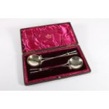 Cased pair of silver plated golfing interest spoons, the handles constructed of two crossed club and
