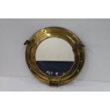 Brass ship's porthole mirror, 29cm diameter and another.