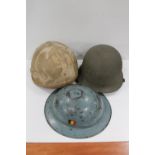 WWII Brodie style helmet with Belgian flag decal and two 'turtle' helmets. (3)