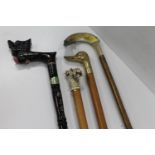 Rabology interest, four walking sticks to include one with carved and painted horn handle in the