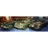 Three large Dartmouth Pottery model cars including an Austin Healey, a E Type Jaguar, and another,