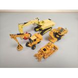 Four West German die-cast model construction toys comprising of a NZG Modelle Excavator 807 &